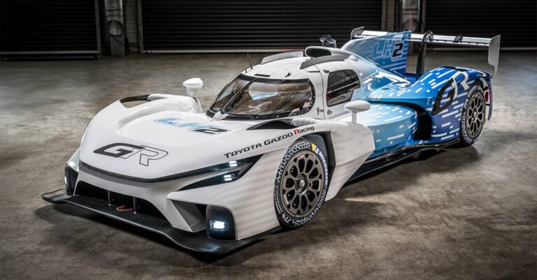 Toyota Gazoo racing unveils liquid hydrogen-fueled GR LH2 Racing Concept, shown here in blue and white livery with a blurred background indicating it is moving at speed.