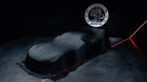 Teaser image of the Mercedes-AMG Concept AMG GT Track Sport - a black vehicle on a black road with a black, murky background