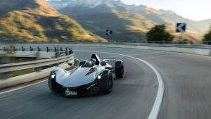 The BAC mono supercar shown driving at speed along a winding mountain road, with the background blurred.