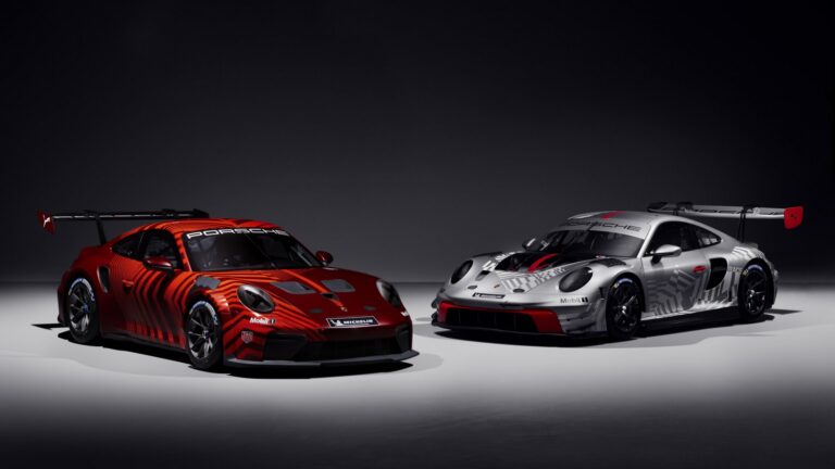 The new 911 Cup, in red, and 911 GT3 R, in grey, sit parked side by side in a showroom