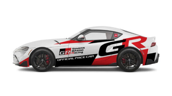 The 2025 Toyota Supra pace car viewed from the left hand side, with a red, black and white livery
