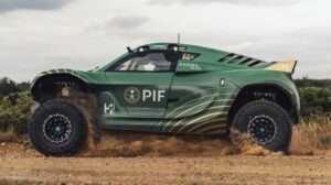 The Pioneer 25 vehicle equipped with Geolandar X-AT tires driving along a dry, sandy dirt road