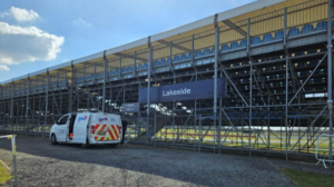 A Kiwa support vehicle parked behind one of the spectator grandstands at Silverstone