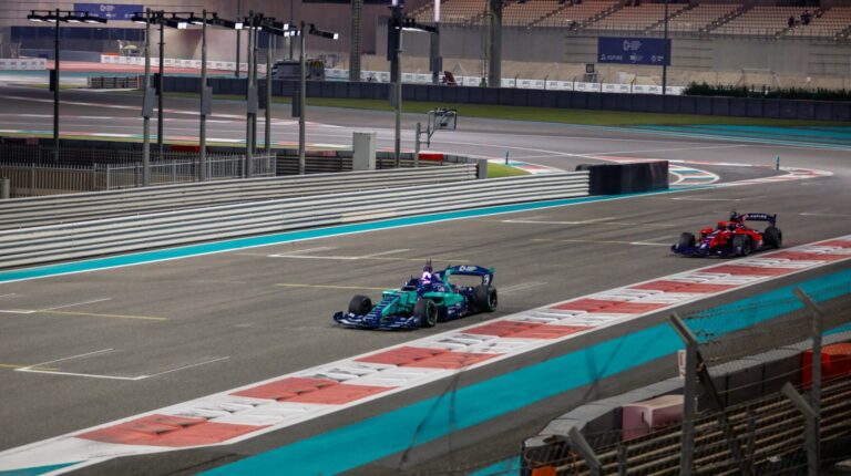 Autonomous racer beats human driver benchmark lap at A2RL Season 2 qualification A Human vs AI demo at Yas Marina Circuit in Abu Dhabi, with two race cars driving down a straight.
