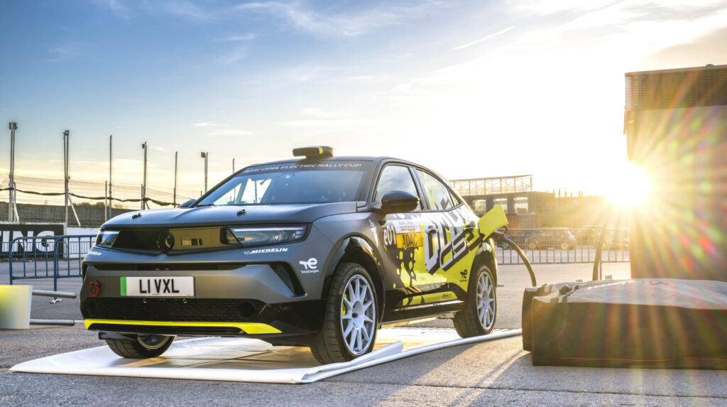 Opel Mokka GSE Rally charing outside in the sun at a race track