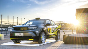Opel Mokka GSE Rally charing outside in the sun at a race track