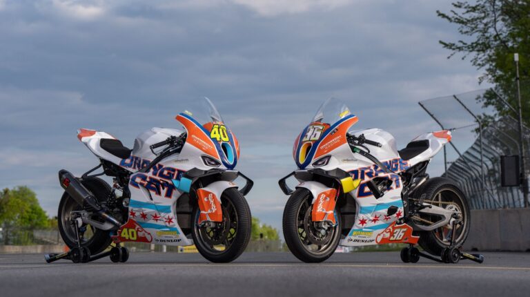 OrangeCat Racing joins 2026 MotoAmerica Superbike Two BMW Motorrad Motorsport bikes parked on an empty racing track, with orange, white and blue OrangeCat Racing livery