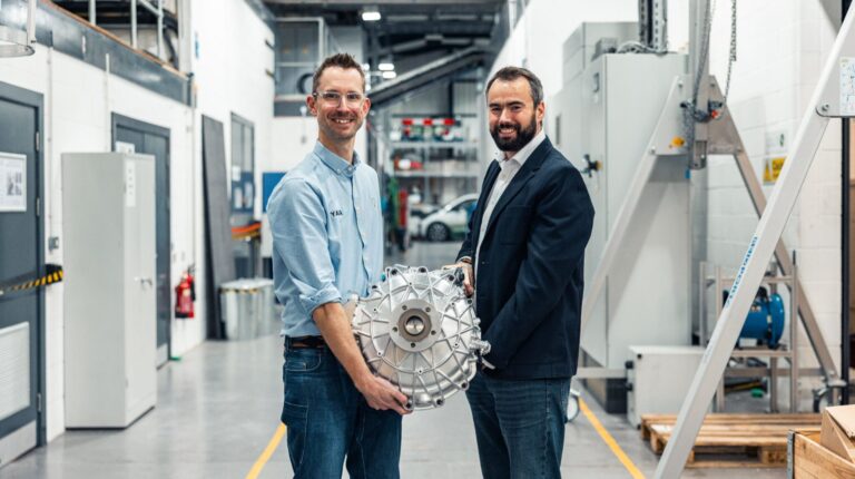 Simon Odling, chief of new technology, and Tim Woolmer, founder and CTO, Yasa, hold the prototype in-wheel electric powertrain system