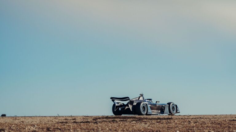 The Porsche Motorsport Gen4 Formula E race car undergoes testing in a dry dessert environment.