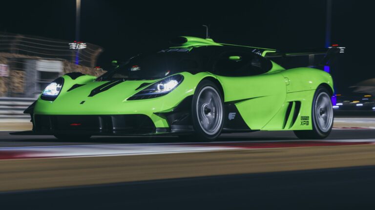 Green T.50s supercar drives round the Bahrain Circuit at night-time.