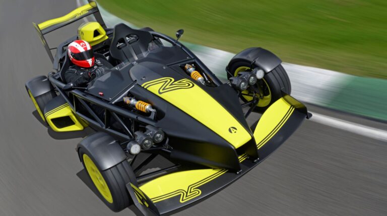 Ariel unveils hand-built, motorsport‑spec Atom 4RR The Ariel Atom 4RR in black and yellow livery drives at high speed on a race track.