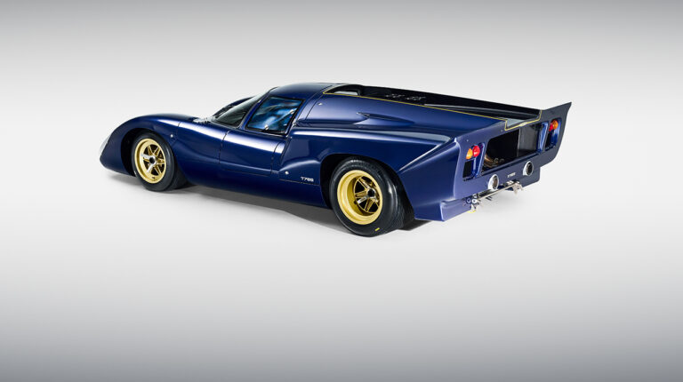 A dark blue Lola Cars T70S against a white background.