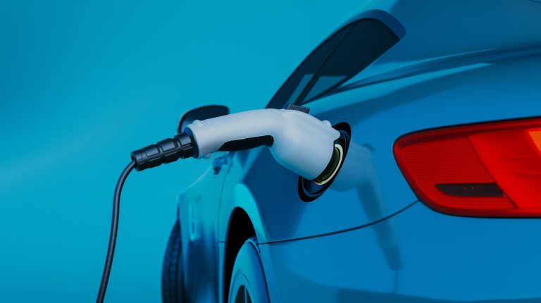 Peak Nano supplies NanoPlex LDF film for Advanced Conversion DC-link capacitors A close-up of an electric car being charged, showing a charging cable plugged into the vehicle's port against a blue background.
