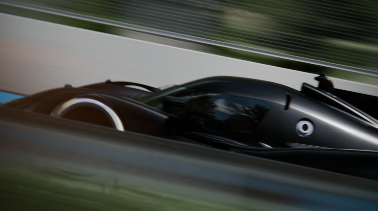 Peugeot begins next phase of 9X8 development The black Peugeot 9X8 drives at speed on a test track. The background is blurred.