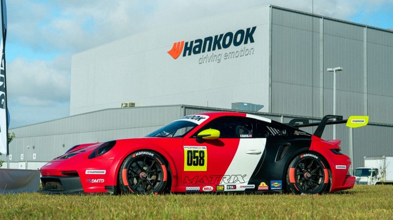 Racing America selects Hankook as official tire partner and exclusive supplier A red race car parked on grass outside Hankook offices